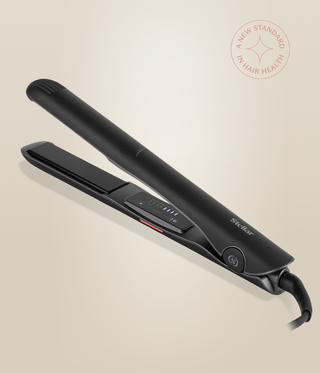 Astral Black Omnia Styler Classic lying open, with its plates and control panel visible.