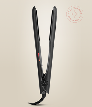 Side view of the Astral Black Omnia Styler Plus standing open, showing its hinge and cord.