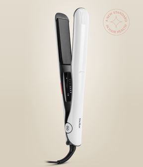 Pearl White Omnia Styler Plus standing upright and open, with its black plate and temperature controls visible.