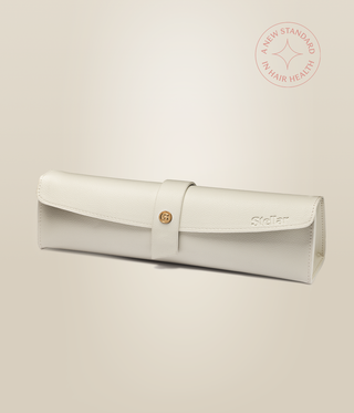 Cream Stellar styler pouch with a wraparound strap, gold fastening and embossed logo.